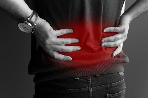 An image of a person with his lower back highlighted in red to indicate lower back pain.
