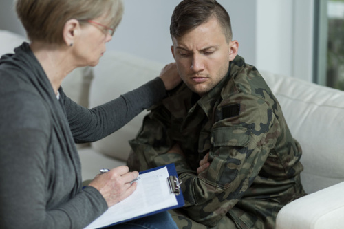 Photo of a veteran being interviewed by a therapist.