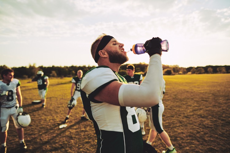 Football player drinks one of the best sports drinks