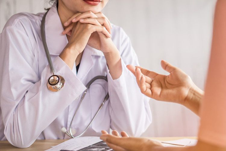 Image of a female doctor speaking with a patient.