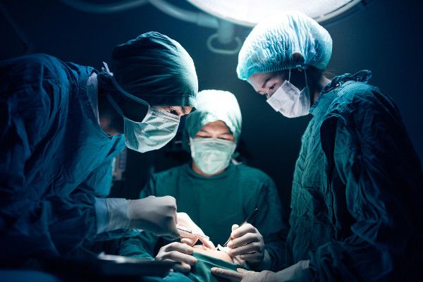 Photo of an operating room with low back surgery in progress.