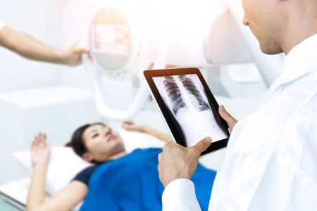 Photo of a doctor viewing an X-Ray prior to a patients low back surgery.