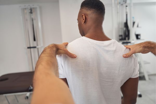 Car accident chiropractor examining a patient’s posture