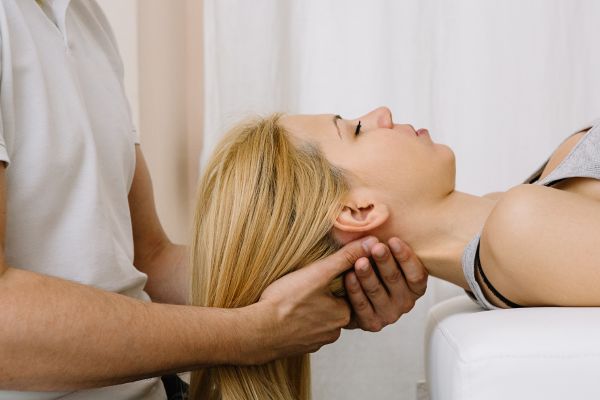 Woman receiving chiropractic treatment for her neck