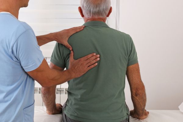 A neck pain chiropractor treats a patient