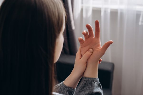 Woman with peripheral neuropathy in her hand