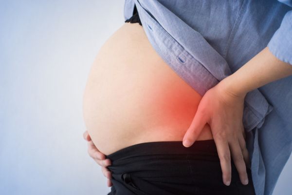 A pregnant woman in need of prenatal chiropractic services